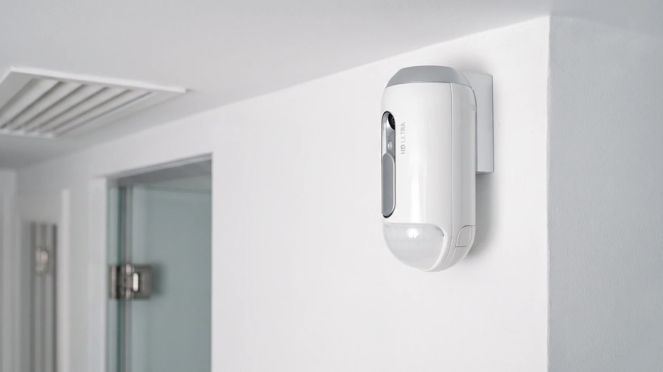 Technicien spécialisé en tenue de travail bleue installant un panneau de contrôle d'alarme anti-intrusion mural dans un intérieur commercial moderne. Le technicien utilise un tournevis pour fixer le boîtier de commande. En arrière-plan, on distingue un environnement professionnel (local technique ou mur blanc commercial). Le panneau d'alarme est visible avec ses connecteurs et son interface, illustrant l'expertise technique de l'installation. L'image capture l'action d'installation professionnelle dans un contexte B2B, reflétant la réactivité et le savoir-faire de FD Sécurité.